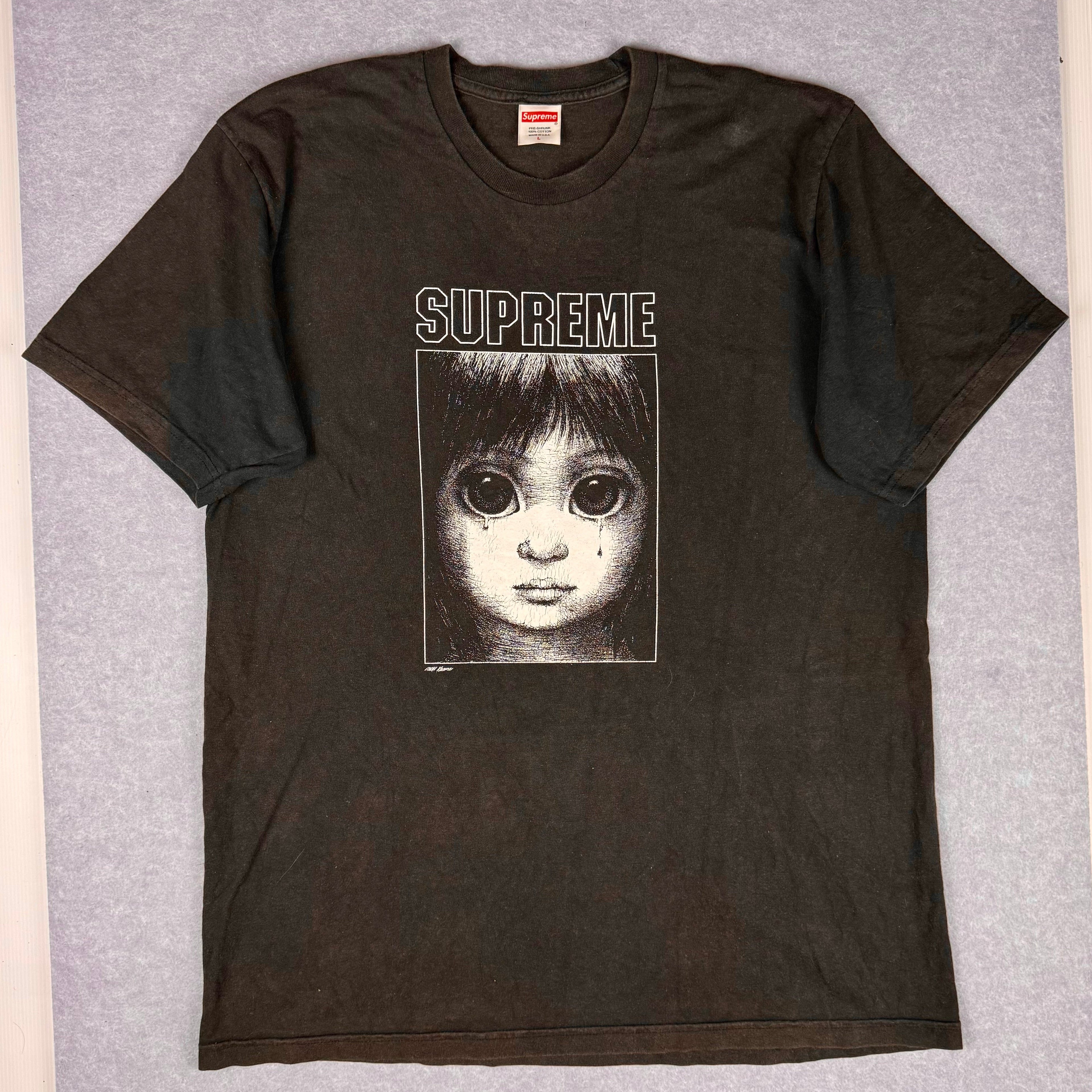 Black Supreme t-shirt with a graphic design on a gray background