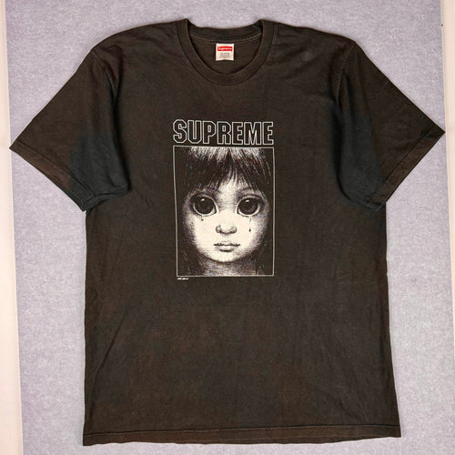 Black Supreme t-shirt with a graphic design on a gray background