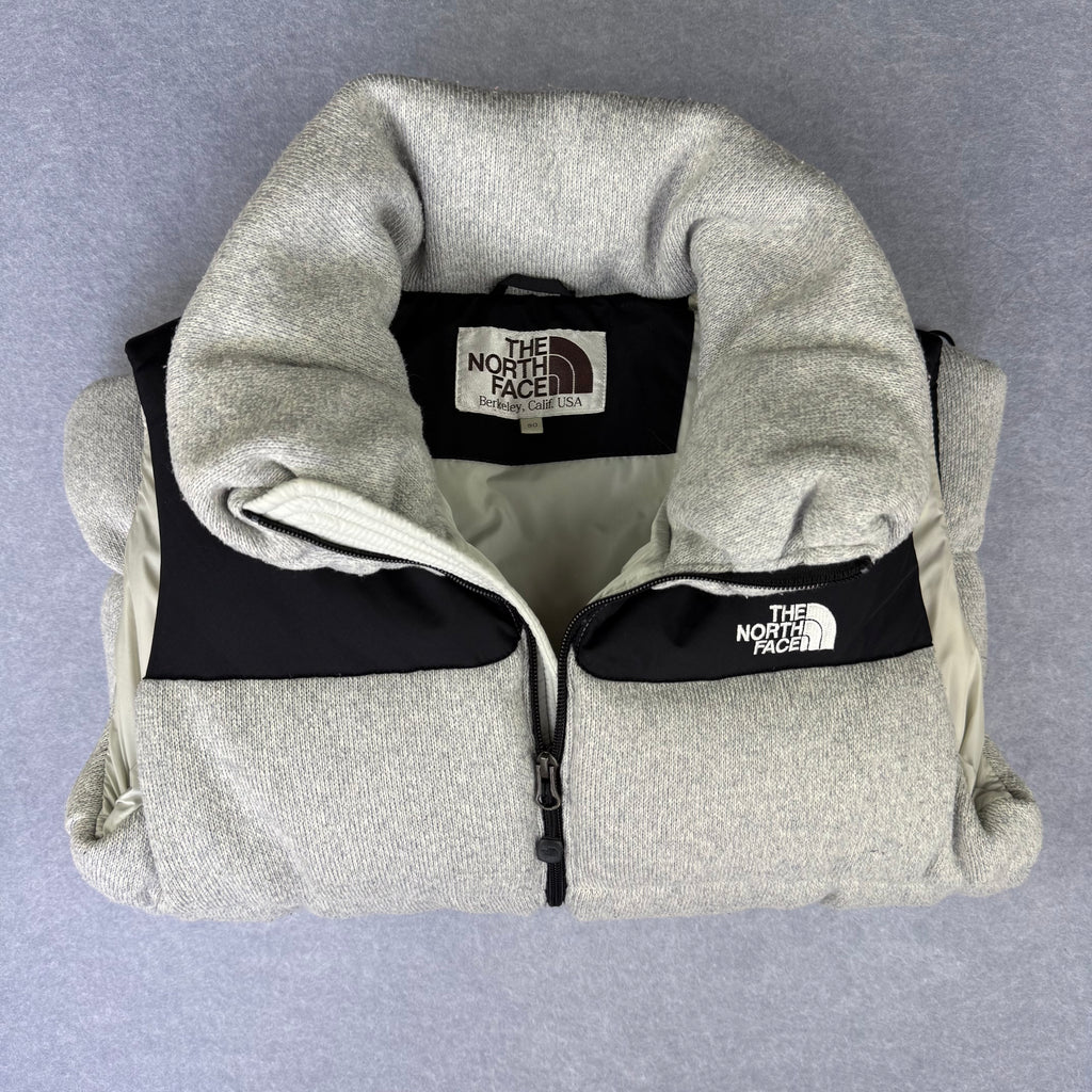 Gray fleece jacket with The North Face logo on a gray background