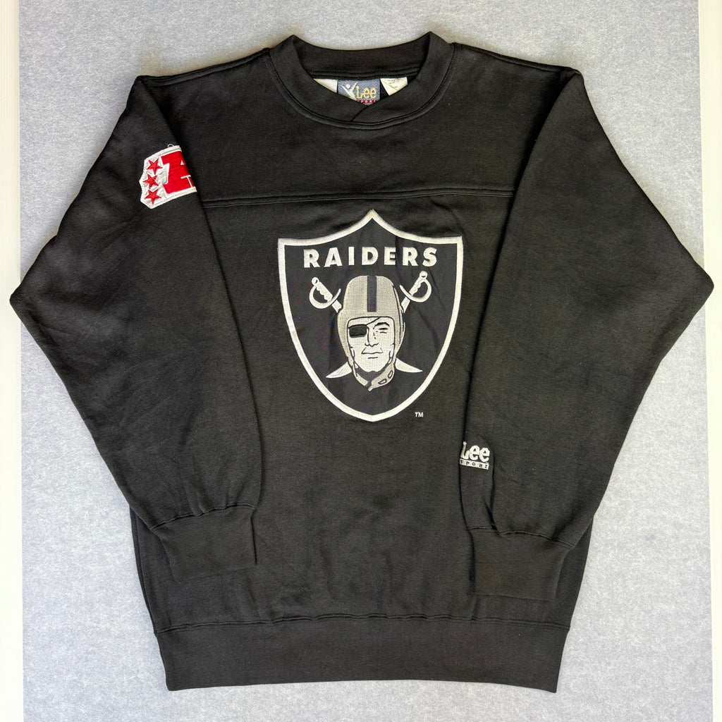 Black sweatshirt with Raiders logo on a gray background