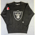 Black sweatshirt with Raiders logo on a gray background