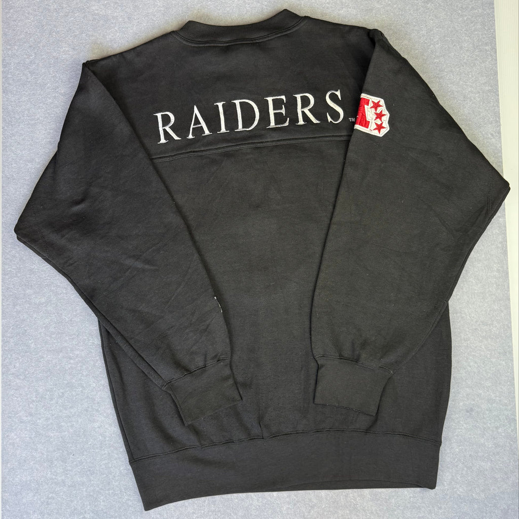 Black sweatshirt with 'RAIDERS' text on a gray surface